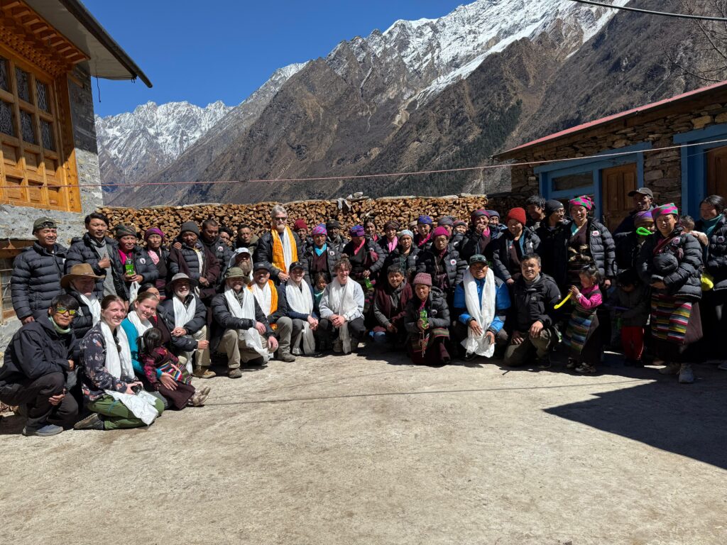 Villagers and trekkers together in a mountain village square